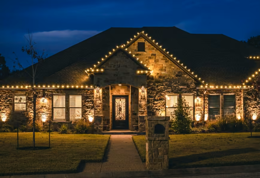 A home illuminated with warm white Christmas lights