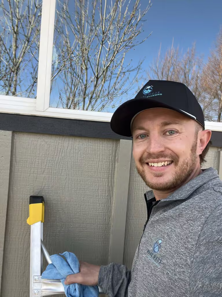 Jake Weakley, owner of Pane Pros Window Cleaning, cleaning a window screen
